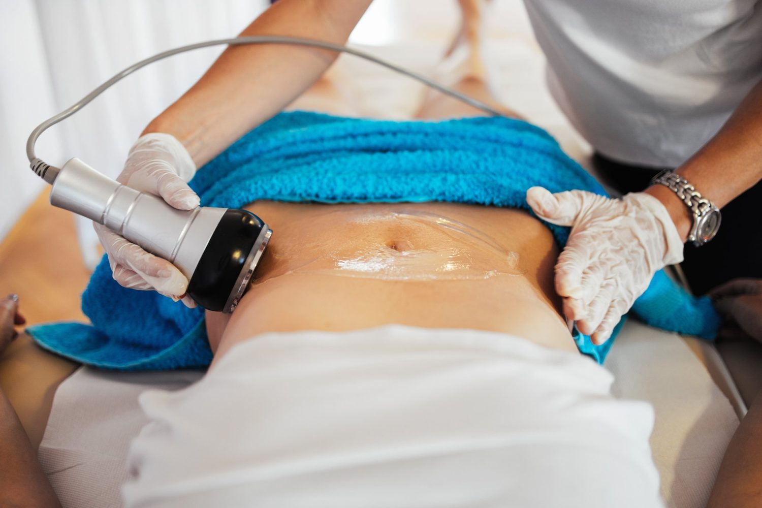 Onda Pro handpiece applied to the abdomen during body contouring treatment